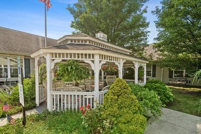 Outdoor seating area with gazebo and greenery