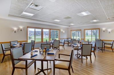Bright dining room with tables and seating for residents