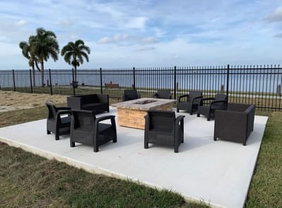 Outdoor seating area with fire pit by the water