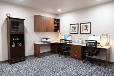 Interior workspace with two computers and decorative elements