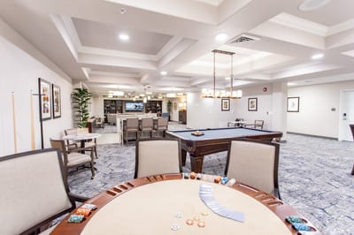 Interior activity room with game tables and pool table