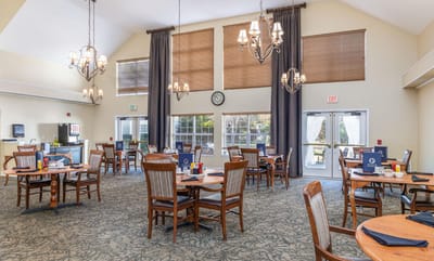 Dining area with tables and chairs, bright lighting