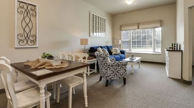 Bright common area with seating and dining table