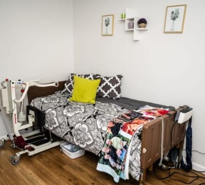 A well-furnished resident room with medical equipment