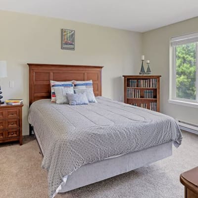 Cozy private resident room with a bed and bookshelves