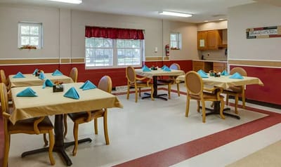 Dining area with set tables and blue napkins