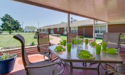 Outdoor dining area with tables set for a meal