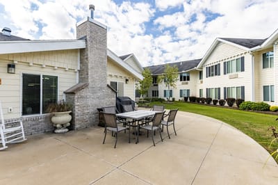 Outdoor patio seating area with a grill