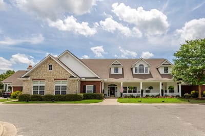 Exterior view of a senior living facility with landscaped entrance