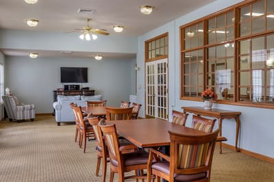 Bright common area with dining tables and chairs