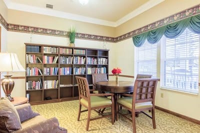 Bright common area with a dining table and bookshelf