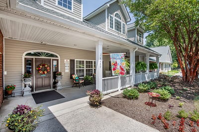 Front entrance of a senior living facility with flowers