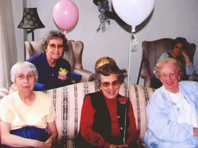 Residents celebrating with balloons in a common area