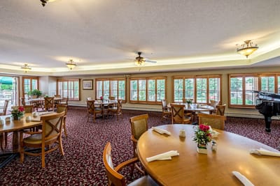 Cozy dining room with large windows and tables