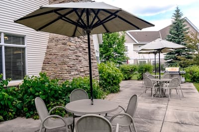Outdoor patio area with tables and umbrellas