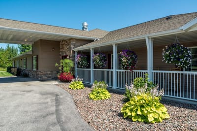 Exterior view of a senior living facility with flowers