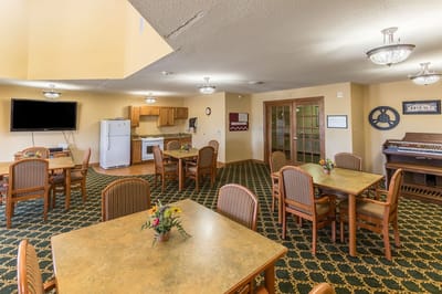 Bright common area with dining tables and kitchenette