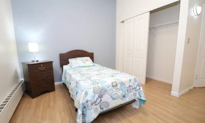 Private resident room with bed and dresser