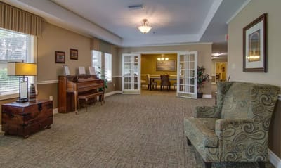 Interior view of a common area with seating and a piano