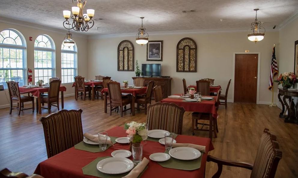 Dining room set up with tables and floral centerpieces