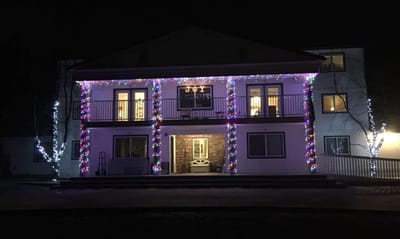 Exterior of assisted living facility decorated with Christmas lights