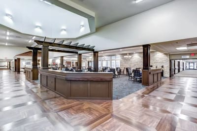 Bright and spacious common area with dining tables