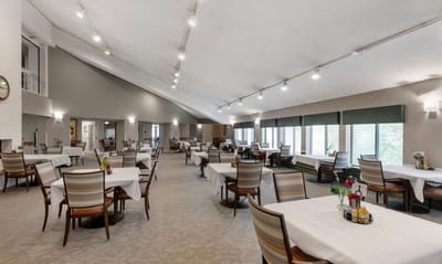 Bright dining room with tables set for meals