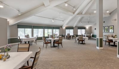 Bright and spacious dining room with tables set for meals