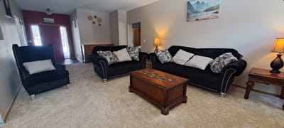 Cozy common area with black sofas and lamps
