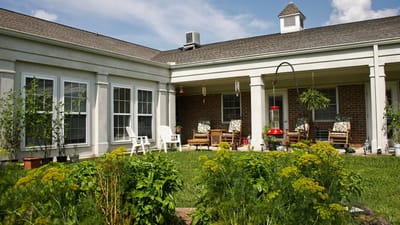 Outdoor patio area with seating and greenery