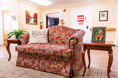 Cozy living area with floral couch and artwork