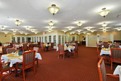 Bright dining room with tables set for meals