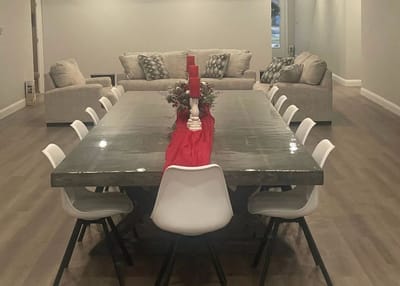Dining room setup with a long table and seating