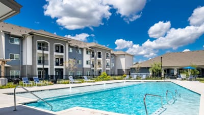 Outdoor pool area with residential buildings