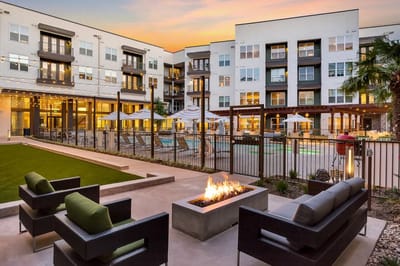 Outdoor seating area with fire pit and pool view