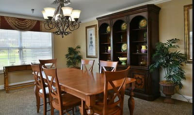 Interior dining area with a wooden table and chandelier