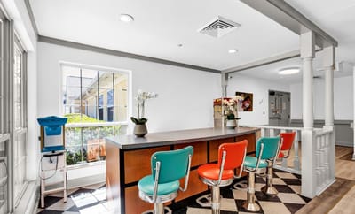 Bright common area with colorful seating and natural light