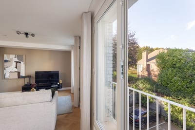 Interior view of a living space with a window overlooking greenery