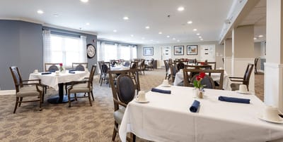 Dining area setup with elegant decor and flower centerpiece