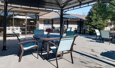 Outdoor seating area with tables and plants