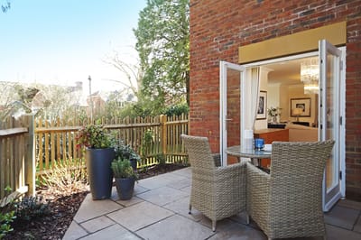 Outdoor seating area with plants and patio furniture