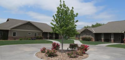 Courtyard with trees and flower beds in a senior living facility