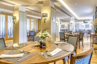 A well-furnished dining area in a senior living facility
