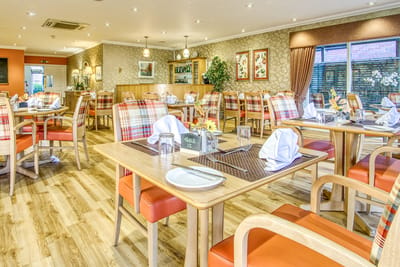 Bright dining room with tables set for a meal