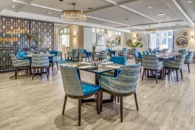 Dining area with stylish blue chairs and tables