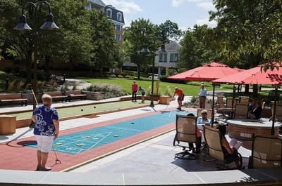 Residents playing bocce ball in a garden area