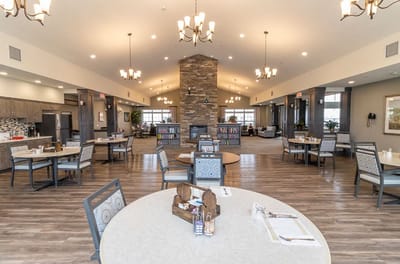 Bright dining room with tables and chairs in a shared area