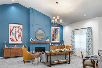 Bright common area with comfortable seating and art