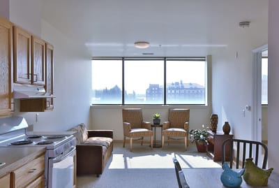 Bright interior of a resident living space with a kitchenette