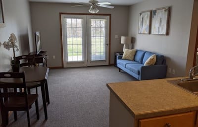 A cozy living room space with access to a patio